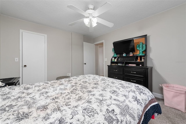 carpeted bedroom featuring a textured ceiling and ceiling fan