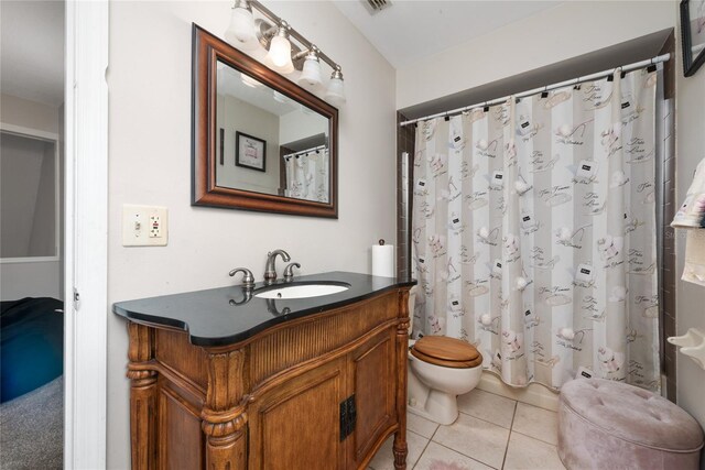 bathroom featuring vanity, toilet, and tile patterned flooring