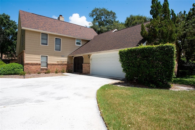 view of front facade featuring a garage and a front lawn