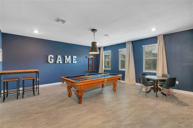 recreation room with billiards and a textured ceiling