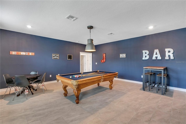 rec room featuring pool table and a textured ceiling