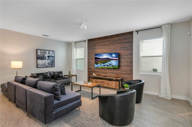 living room with plenty of natural light and wooden walls