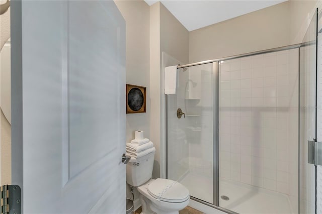 bathroom with an enclosed shower and toilet