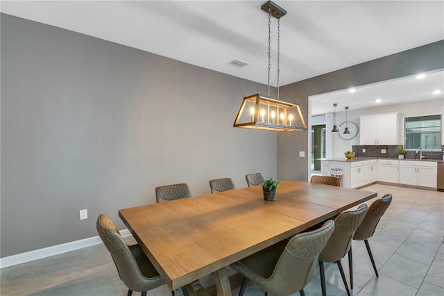 dining area featuring light tile patterned flooring and sink