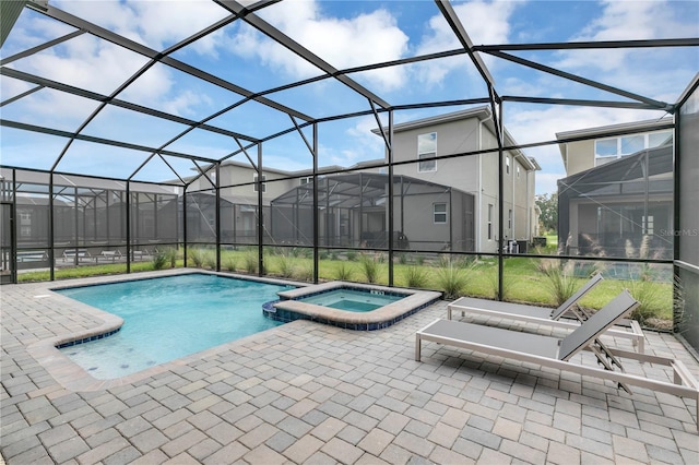 view of swimming pool featuring an in ground hot tub, glass enclosure, and a patio