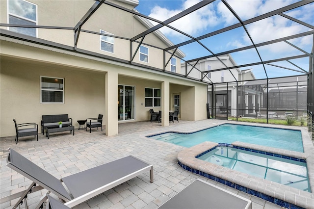 view of swimming pool with a patio area, outdoor lounge area, glass enclosure, and an in ground hot tub