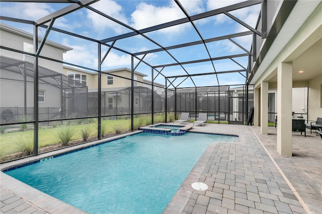 view of swimming pool featuring an in ground hot tub, a lanai, and a patio