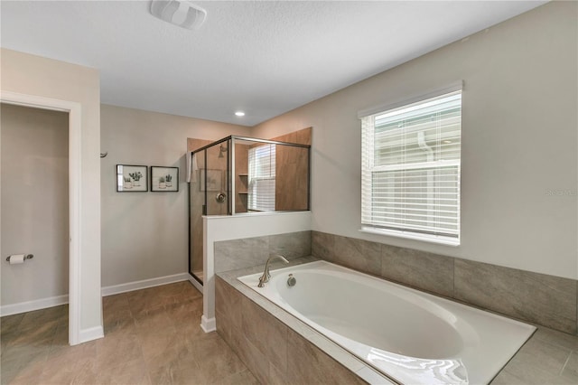 bathroom featuring shower with separate bathtub