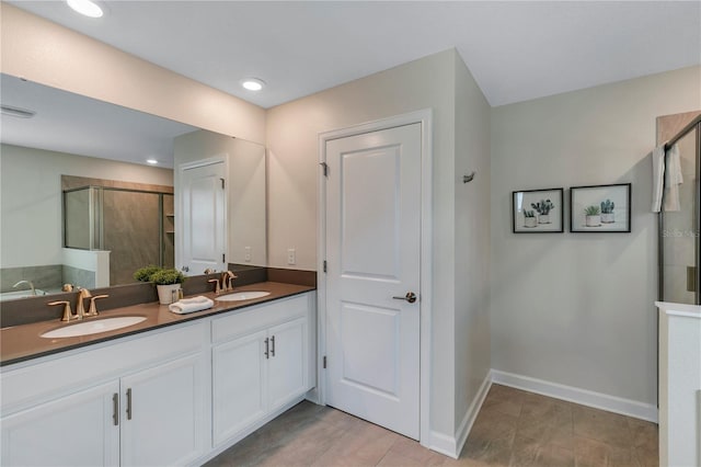 bathroom featuring vanity and a shower with door