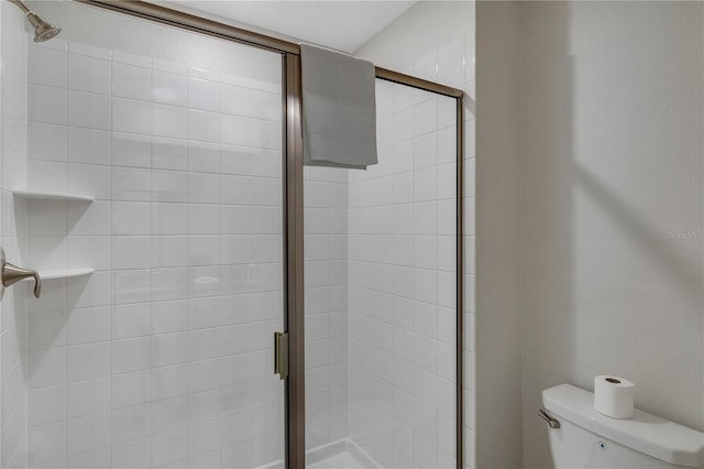 bathroom with toilet and walk in shower