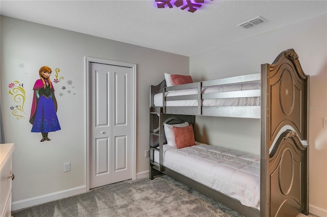 bedroom featuring carpet floors and a textured ceiling