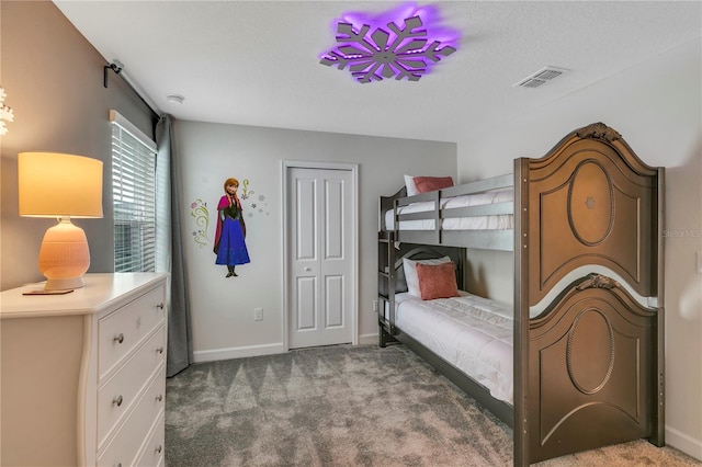 carpeted bedroom featuring a textured ceiling