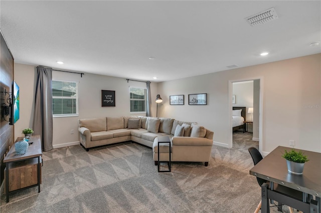 living room with a wealth of natural light and light carpet