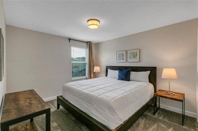 bedroom featuring dark colored carpet