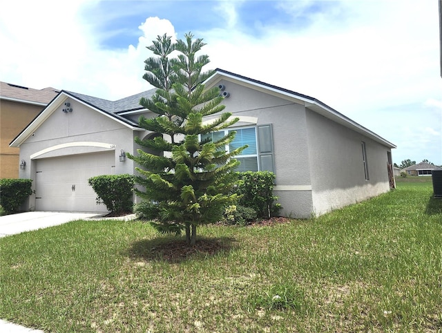 view of front of house featuring a garage and a front lawn