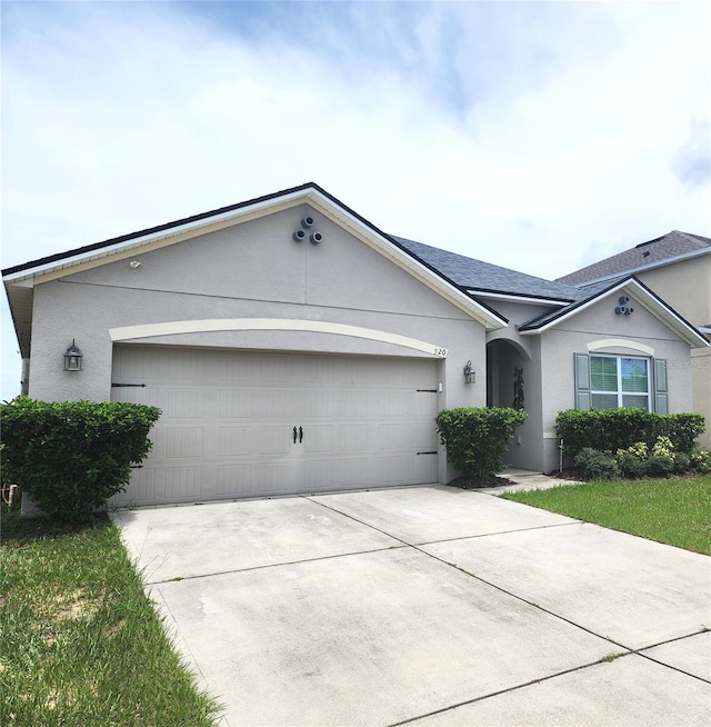 single story home featuring a garage