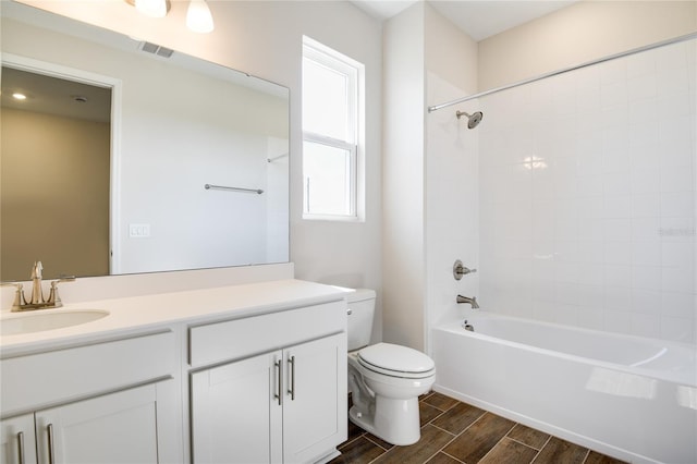 full bathroom with vanity, toilet, and tiled shower / bath