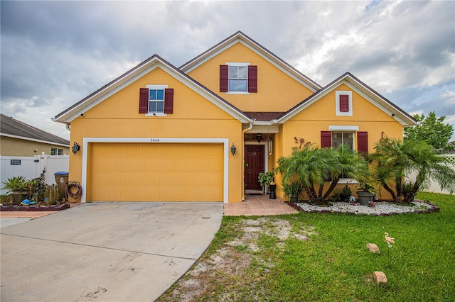 view of front of house with a garage and a front yard