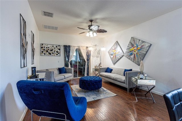 living room featuring a textured ceiling, wood-type flooring, and ceiling fan