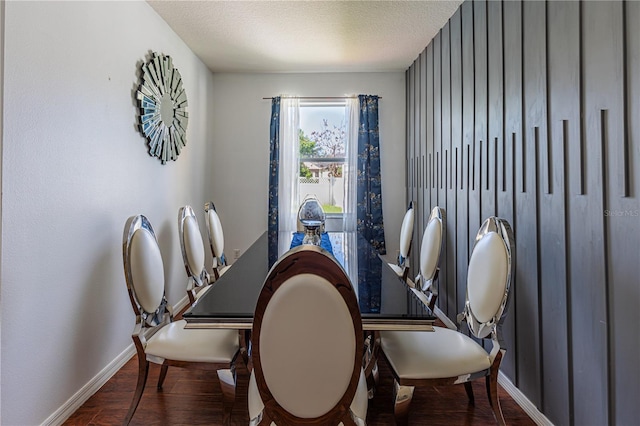 dining space featuring a textured ceiling and hardwood / wood-style flooring