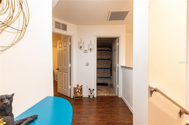 hallway with dark hardwood / wood-style flooring