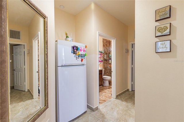 kitchen featuring white refrigerator and light tile patterned floors