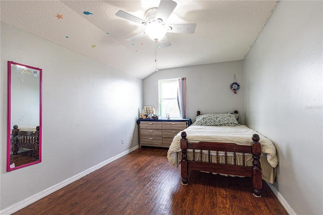 bedroom featuring dark hardwood / wood-style flooring, a textured ceiling, ceiling fan, and vaulted ceiling