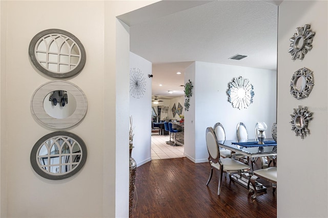 dining area featuring a textured ceiling, ceiling fan, and hardwood / wood-style floors