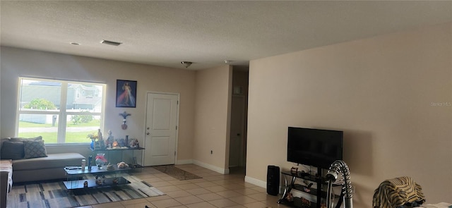 tiled living room with a textured ceiling