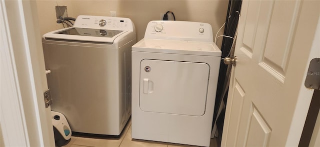 washroom featuring light tile patterned floors and separate washer and dryer