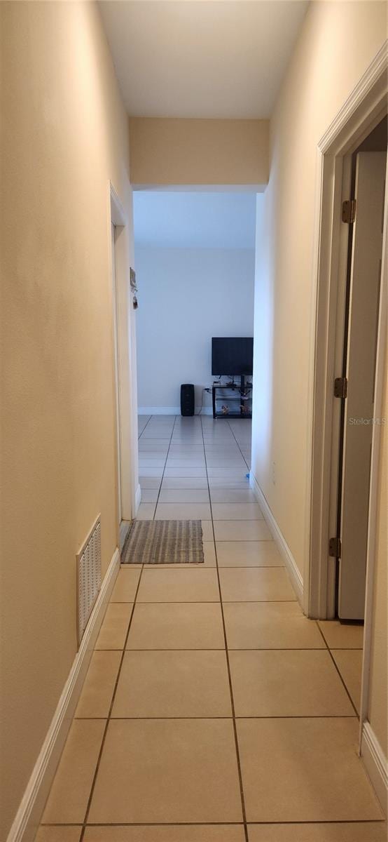 corridor featuring light tile patterned floors