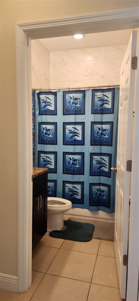 bathroom featuring toilet, vanity, and tile patterned flooring