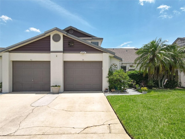 view of front of property featuring a garage and a front lawn