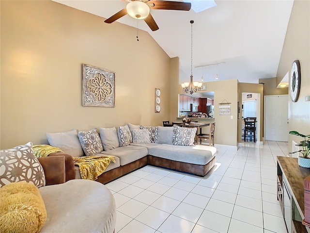 living room with ceiling fan with notable chandelier, light tile patterned floors, track lighting, and high vaulted ceiling