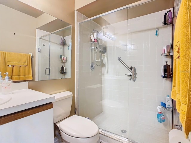 bathroom featuring vanity, toilet, and an enclosed shower