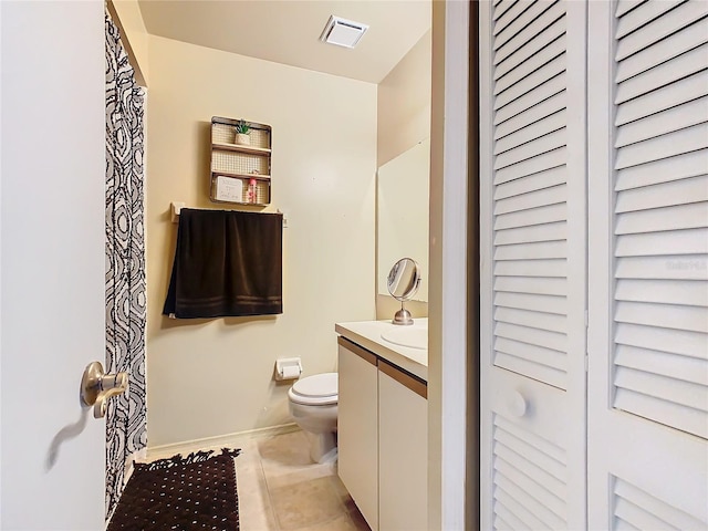 bathroom with vanity, tile patterned floors, and toilet