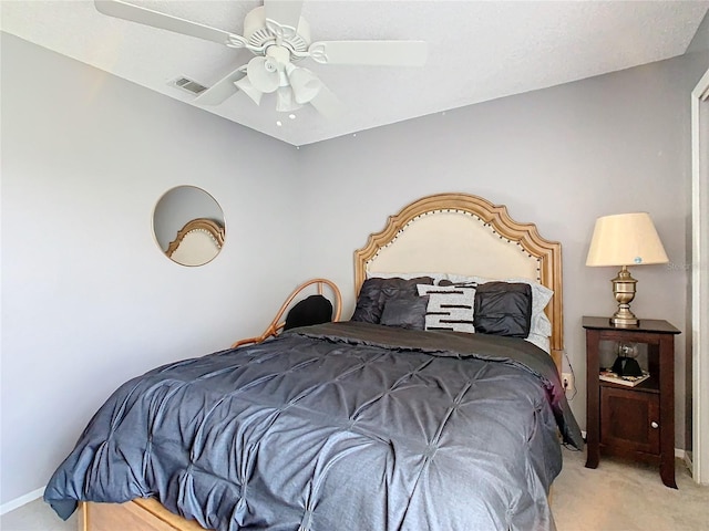 bedroom featuring light carpet and ceiling fan