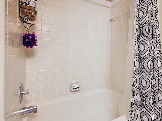 bathroom with shower / bath combo with shower curtain