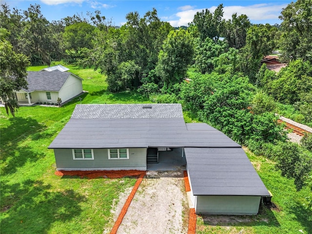 view of outbuilding with a yard and a carport