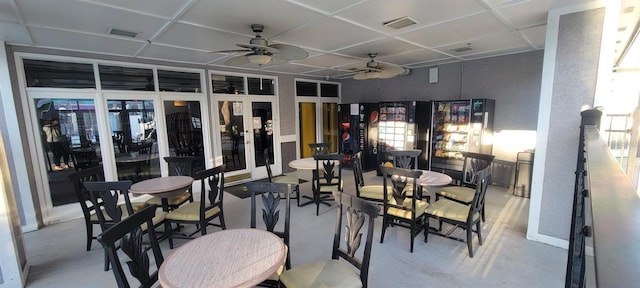 dining room with ceiling fan and concrete floors