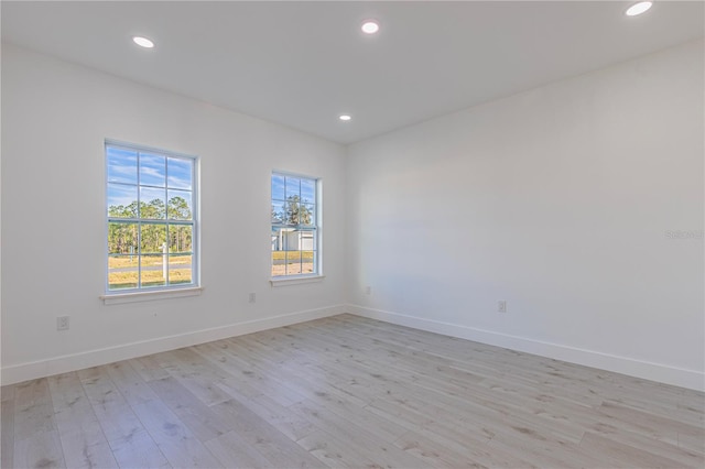 unfurnished room featuring light hardwood / wood-style floors