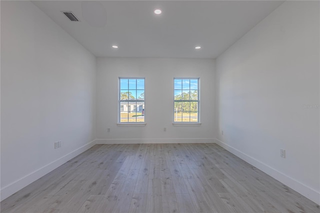 spare room featuring light hardwood / wood-style flooring