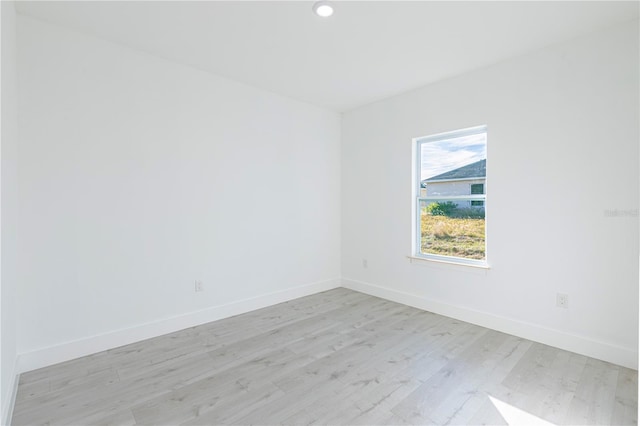 empty room with light hardwood / wood-style flooring