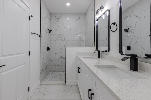 bathroom featuring tiled shower and vanity