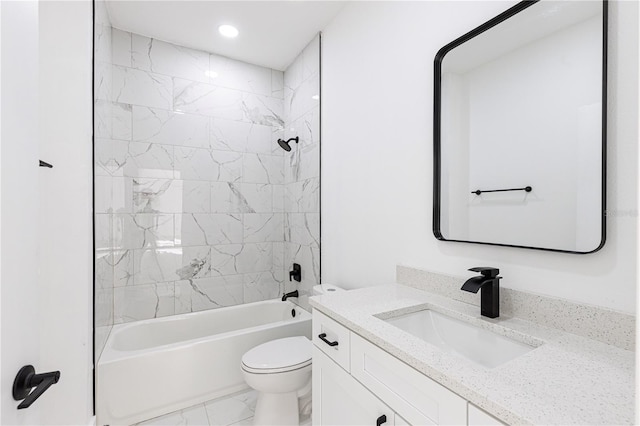 full bathroom featuring vanity, tiled shower / bath combo, and toilet