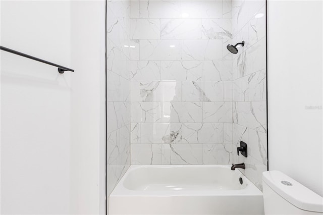 bathroom with tiled shower / bath combo and toilet