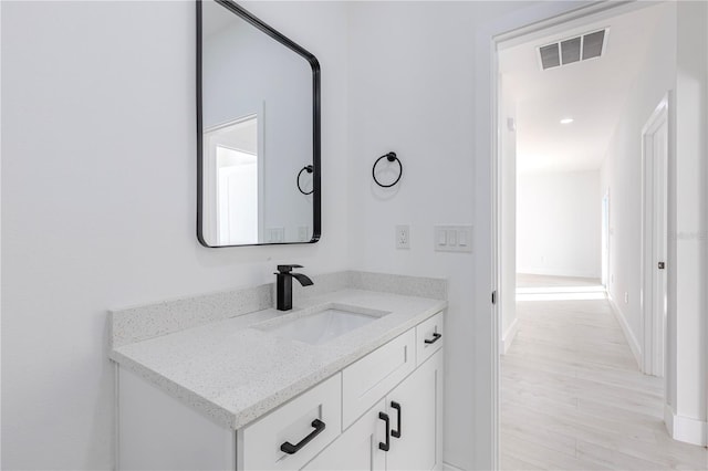 bathroom featuring hardwood / wood-style floors and vanity