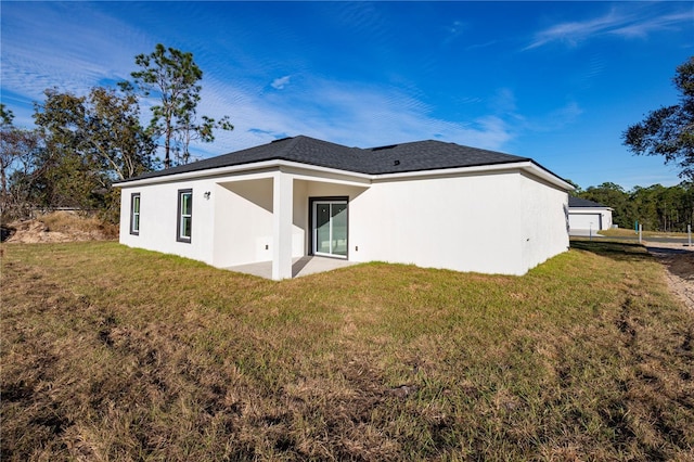 back of property featuring a lawn