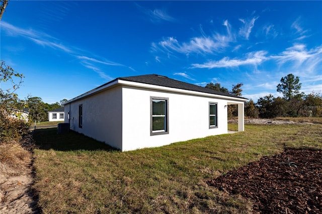 view of home's exterior featuring a yard and central AC