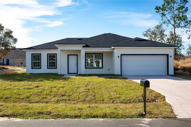 view of front of home featuring a garage and a front yard